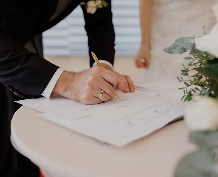 Signing a marriage certificate at a wedding ceremony