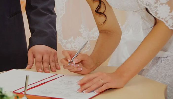 Bride signing a marriage certificate
