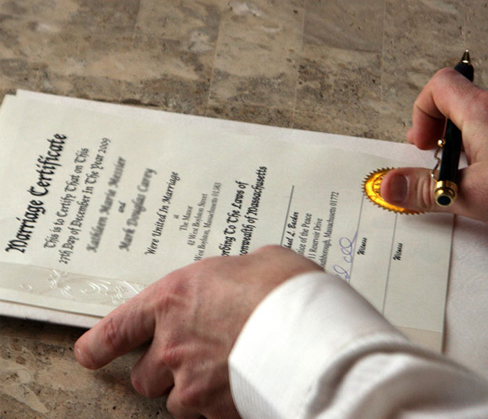 Close-up of a marriage certificate being signed